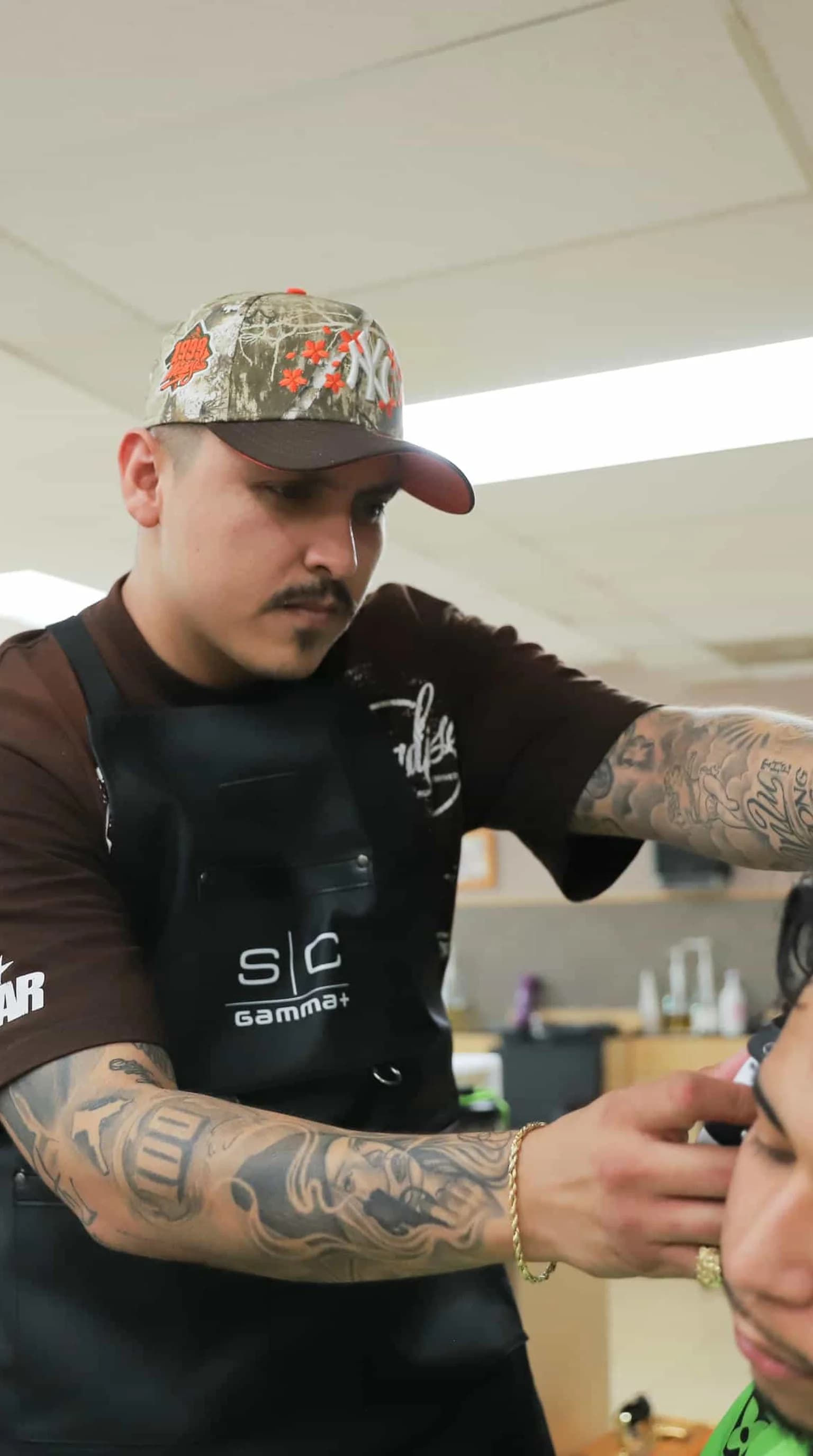 Barbering student in modern barbershop