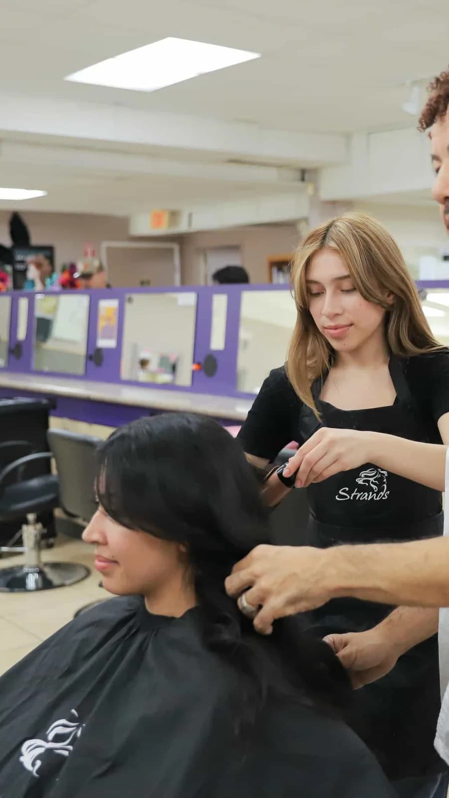 Cosmetology students training in a salon classroom