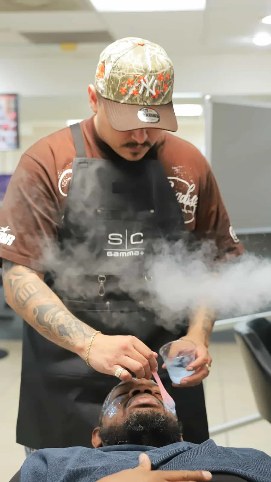 Instructor giving a facial steam treatment in the student clinic